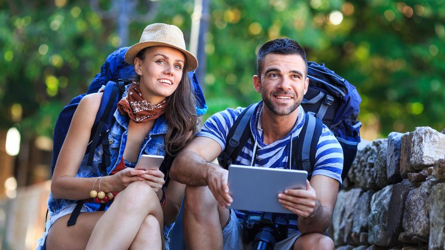 eco-tourists with a digital guide on the tablet / mobile phone