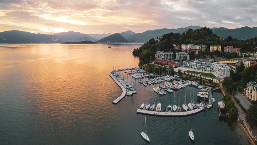 Panoramic view of Laveno-Mombello marina on Lake Maggiore at sunset.