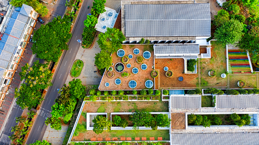 Aerial view of green roofs and sustainable buildings surrounded by vegetation.