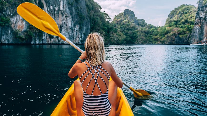 Woman exploring Palawan by kayak