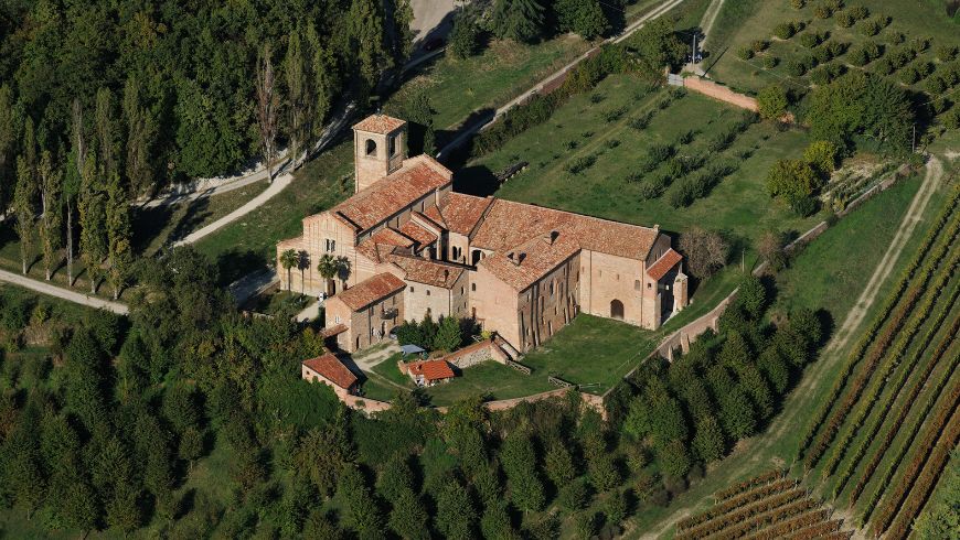 Aerial view of Vezzolano Romanesque Abbey, set within a green landscape