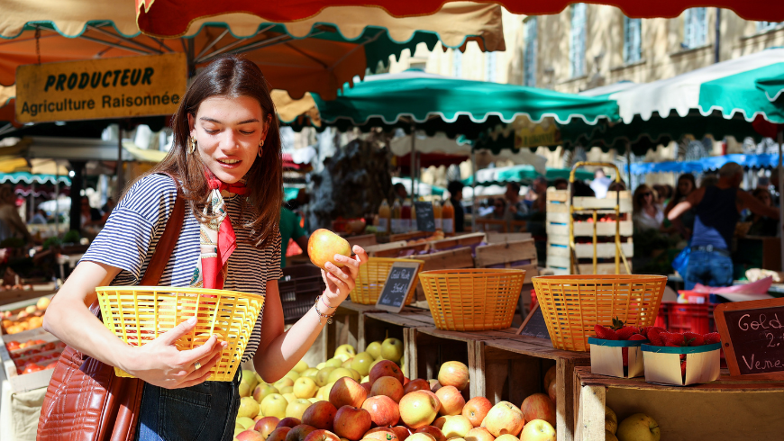Woman shopping for fresh produce at a local farmers’ market