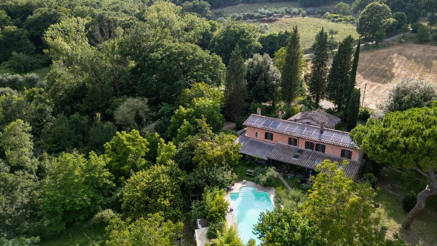 accommodation surrounded by greenery, with solar panels on the roof
