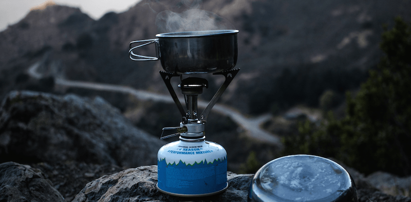 Camping-Kocher vor einer Bergkulisse