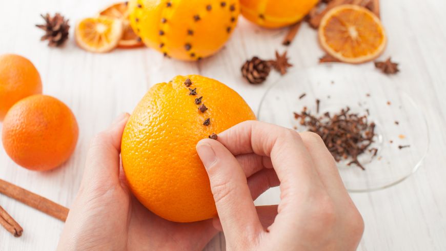 Natürliche Weihnachtsdekorationen mit Orangen, Tannenzapfen, Zimt und Nelken